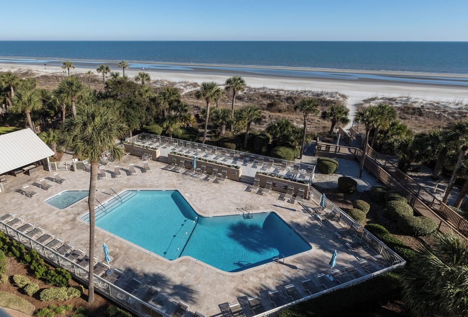 View of pool and pool house on left