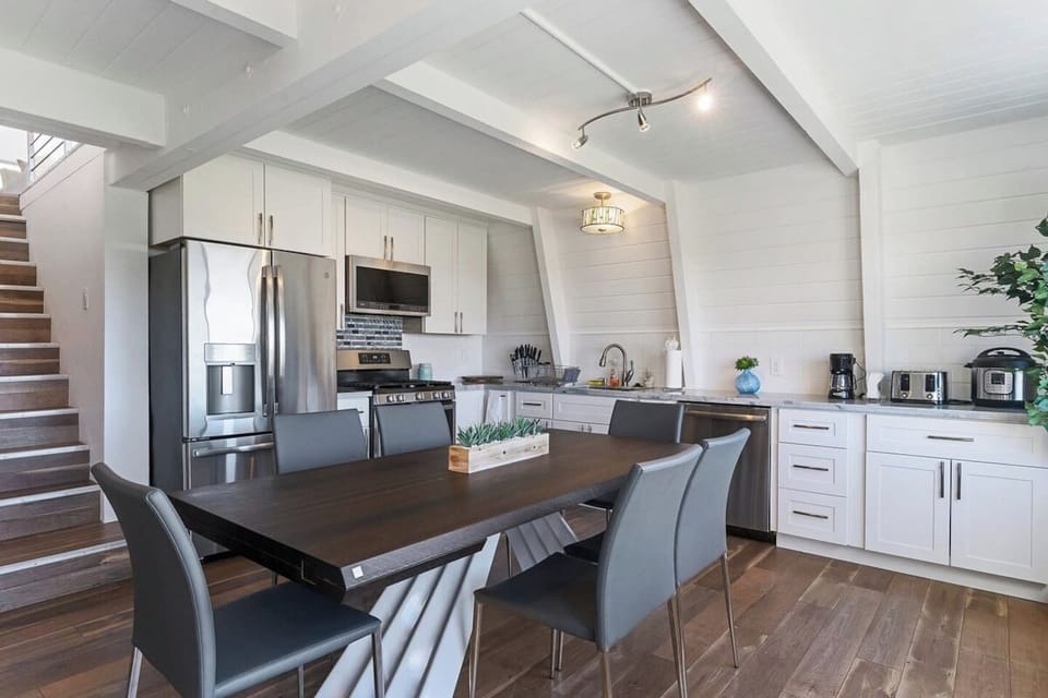 Spacious dining/kitchen area with an extendable table that can seat 8-12 guests in the 3-bedroom unit.