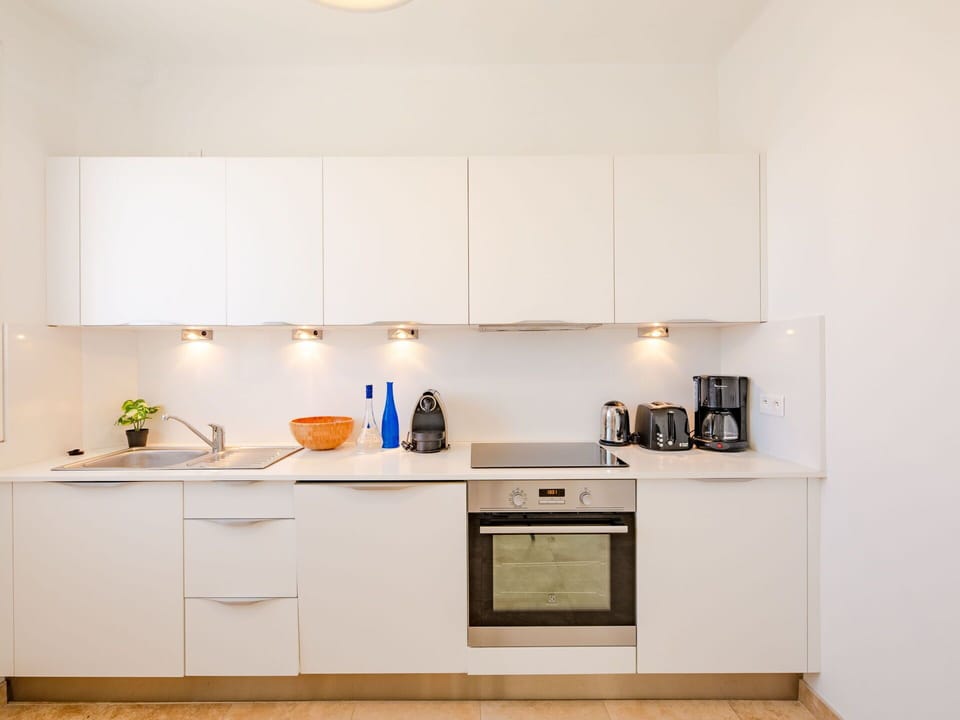Cabinetry, Countertop, Building, Kitchen, Wood, Interior Design, Kitchen Stove, Lighting, Sink, Kitchen Appliance
