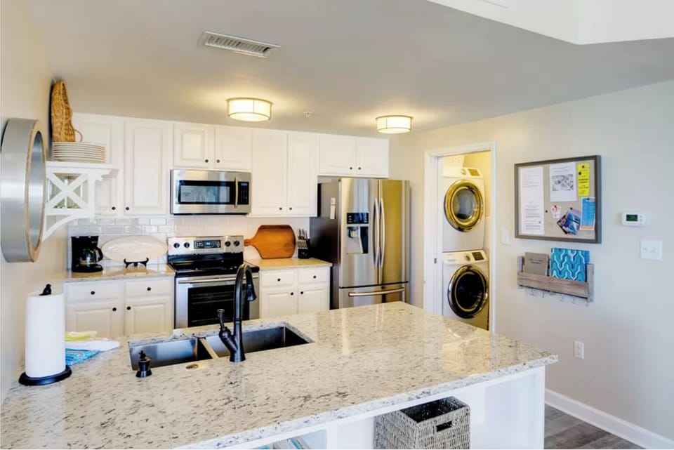Your fully equipped kitchen features granite counters, stainless appliances, and convenient in-unit washer and dryer for effortless meal prep and stay.