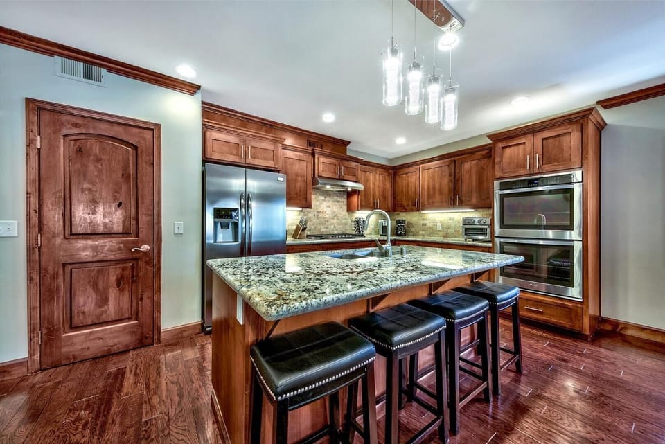 Your gourmet kitchen awaits with granite countertops, stainless steel appliances, and a spacious island perfect for cooking memorable meals together.