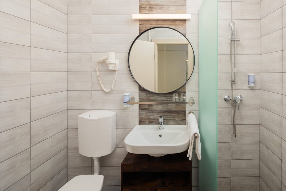 Shower, hair dryer, towels, toilet paper
