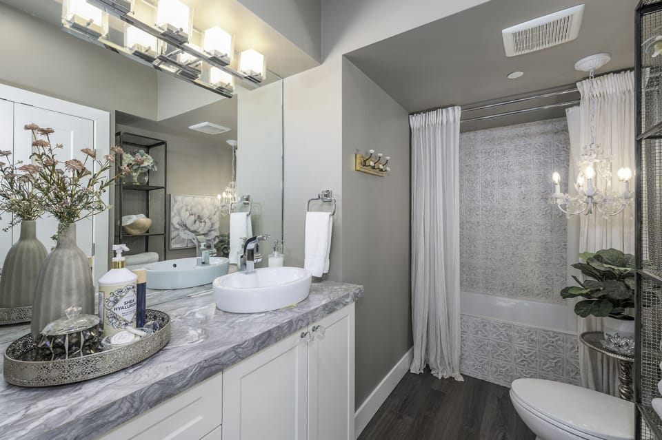 Large vanity and soaker tub/shower combo. 
Fluffy white towels to dry off with!