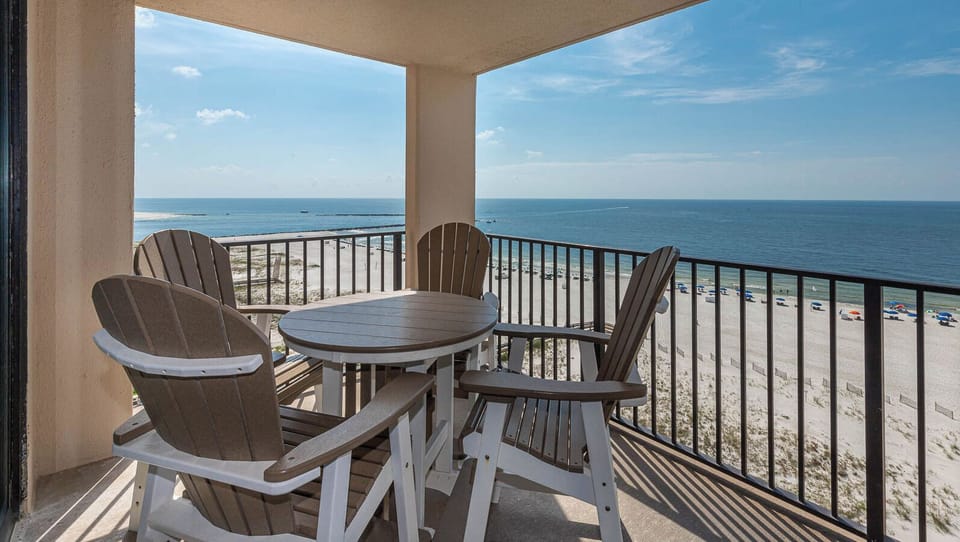 Relax at the balcony, enjoying refreshing breezes and views of the coast and colorful beach umbrellas