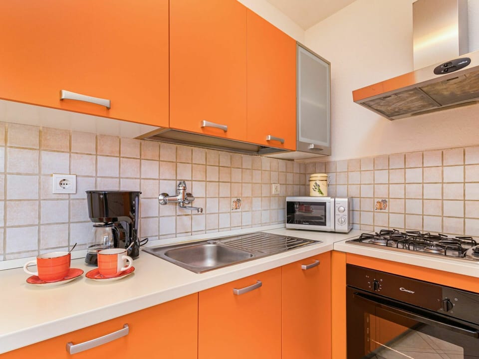 Property, Room, Orange, Kitchen, Cabinetry, Countertop, Furniture, Yellow, Interior Design, Real Estate