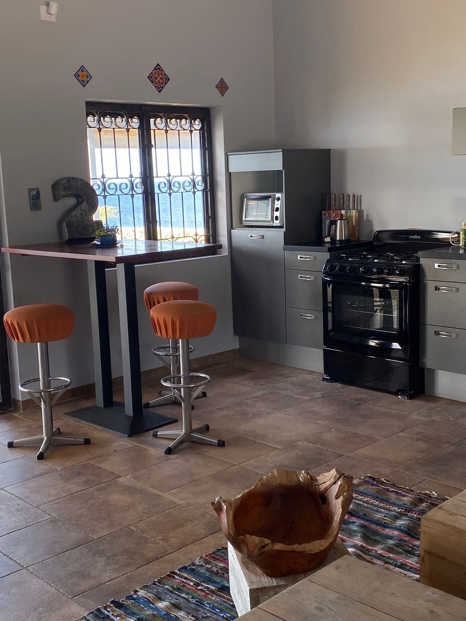 The kitchen has a bar for food prep or dining in.