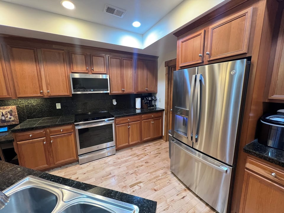 Kitchen with stove, dishwasher, microwave, refrigerator and Keurig coffee maker