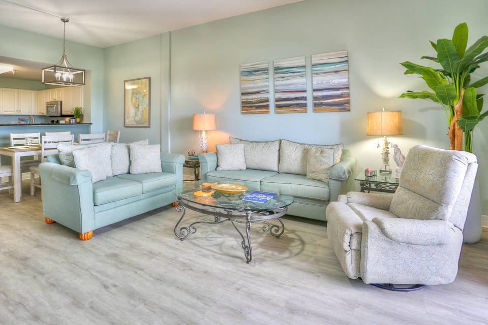 Spacious Living Room Area with Balcony Access, Excellent Views, Plenty of Seating, and Large Flat Screen TV