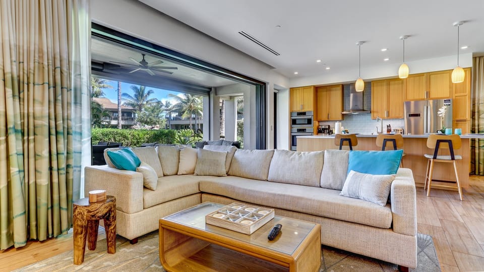 Disappearing pocket doors in the living room open to the large covered lanai