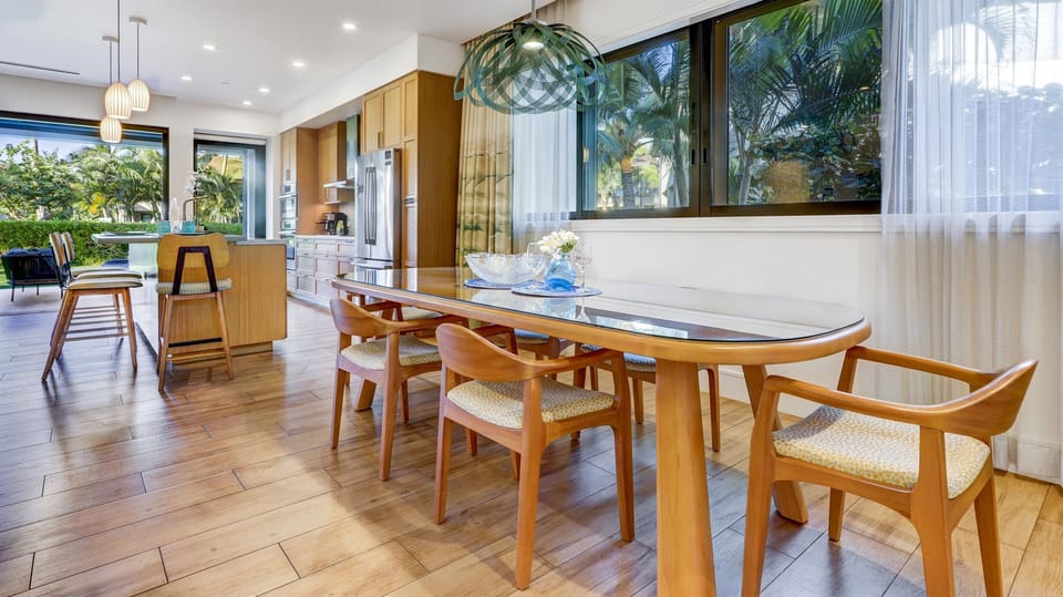 Dining table hosts 6 guests with additional bar seating at the kitchen island