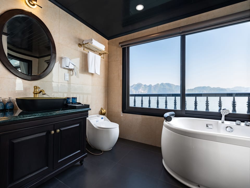 Bathtub, designer toiletries, hair dryer, bathrobes