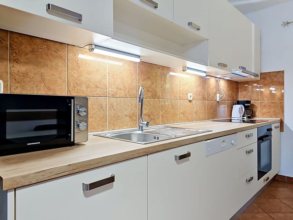 Countertop, Kitchen, Kitchen Appliance, Major Appliance, Cabinetry, Wood, Flooring, Interior Design, Home Appliance, Sink