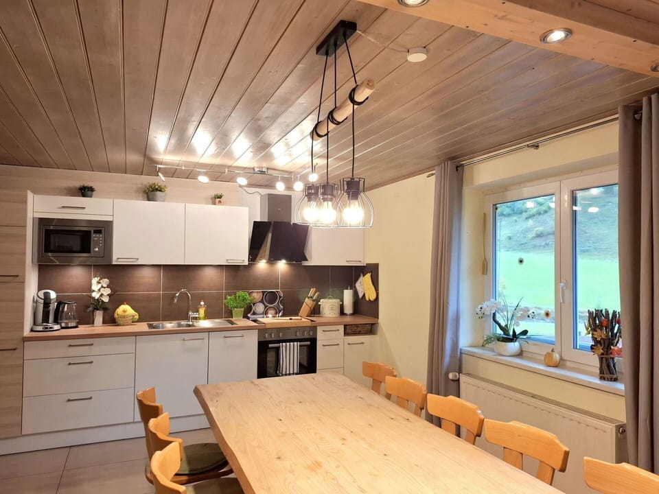 Interior Design, Furniture, Light Fixture, Flooring, Wood, Ceiling, Kitchen, Countertop, Floor, Kitchen & Dining Room Table