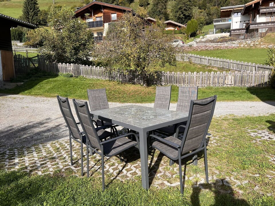 Plant, Table, Furniture, Building, Outdoor Table, Outdoor Furniture, Tree, Land Lot, Chair, Grass