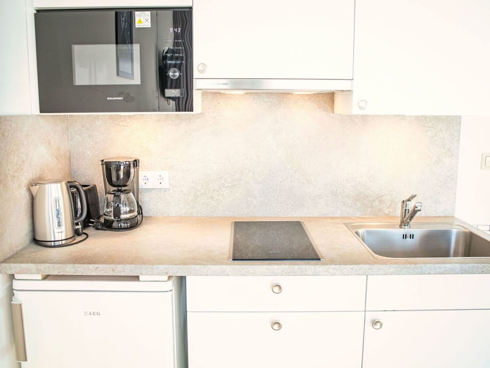 Countertop, Kitchen, Cabinetry, Kitchen Appliance, Kitchen Sink, Interior Design, Plumbing Fixture, Sink, Tap, Major Appliance