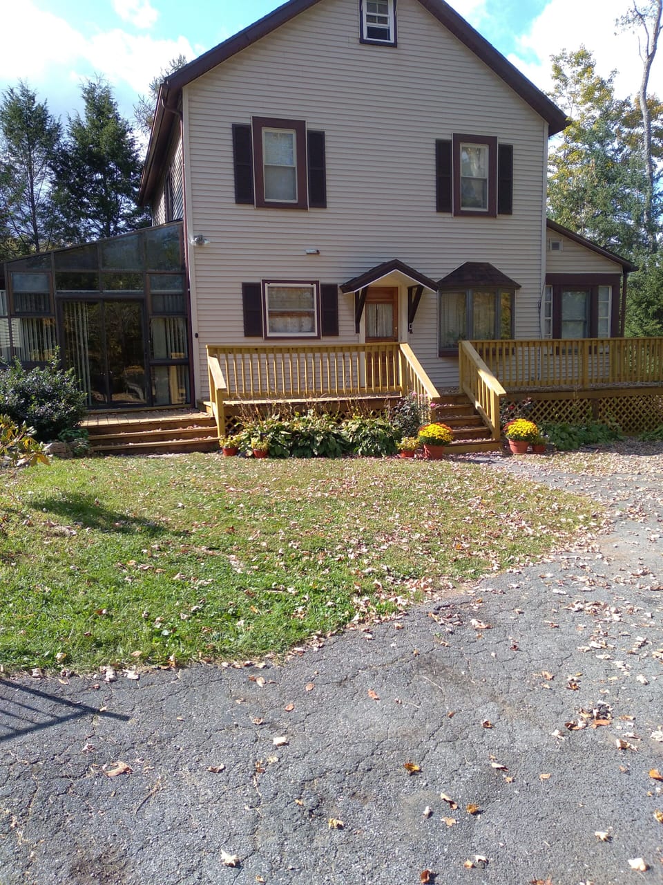 East-Facing front of house. (4 Seasons Sunroom on left. Enclosed porch on right)