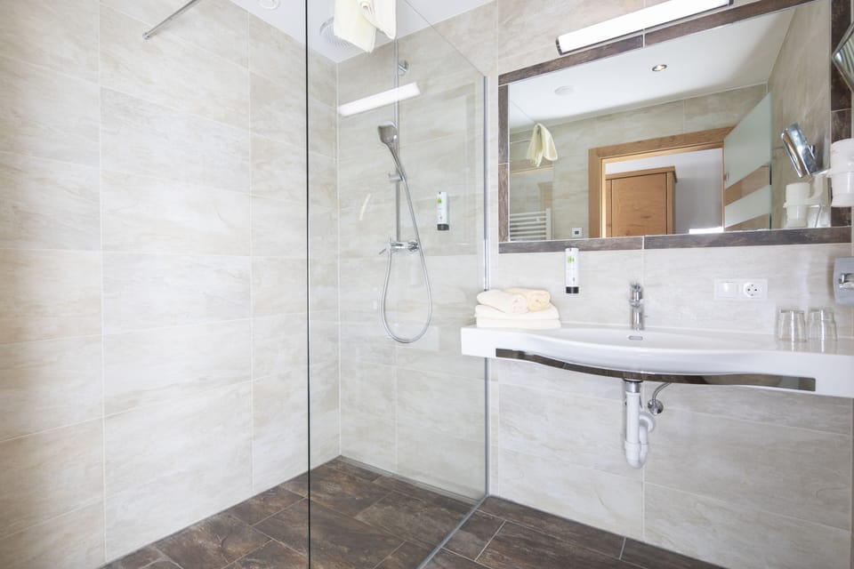 Deluxe Double Room, 1 Queen Bed | Bathroom | Shower, rainfall showerhead, hair dryer, bathrobes