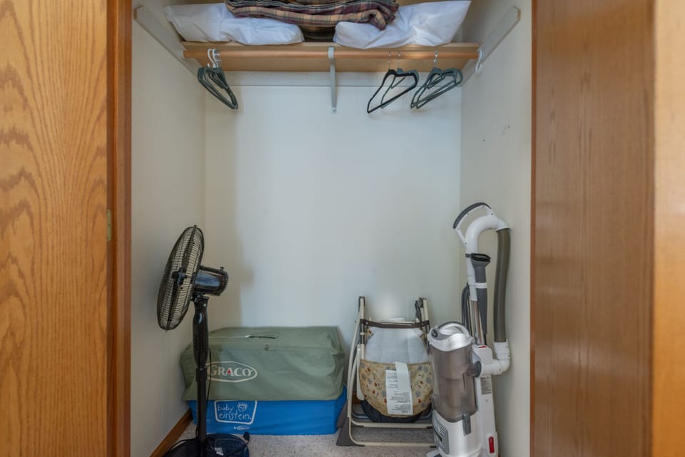 Main floor king closet holds two high chairs & 2 pack-n-plays for little guests