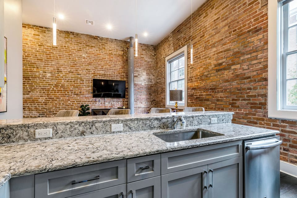 Cook and dine easily in the fully stocked kitchen, equipped with all stainless steel appliances, gas range, basic cookware, and a dining area for a comfortable meal at home. Entertain at the bar with seating for four.