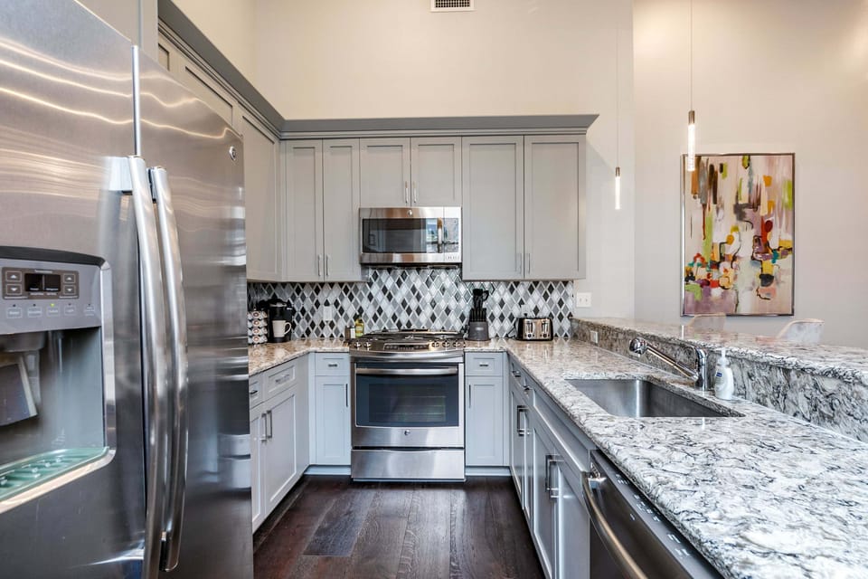 Cook and dine easily in the fully stocked kitchen, equipped with all stainless steel appliances, gas range, basic cookware, and a dining area for a comfortable meal at home. Entertain at the bar with seating for four.