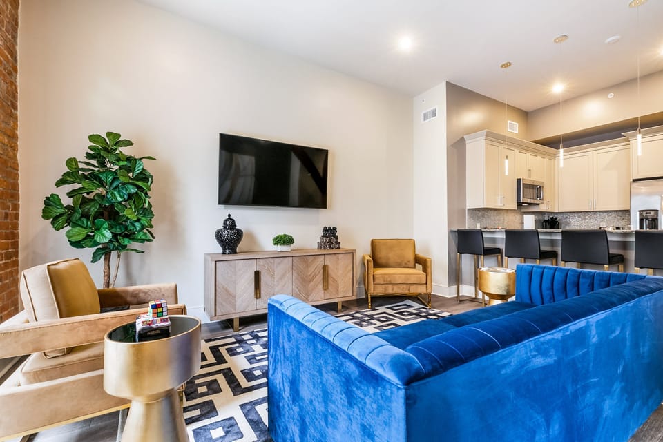 Open-concept living, kitchen, and dining area with plenty of seating. Enjoy a 65” Samsung Smart 4K TV with streaming and DIRECTV Entertainment. The sofa converts to a queen-size sleeper, and the dining table seats four. Lots of natural light too!
