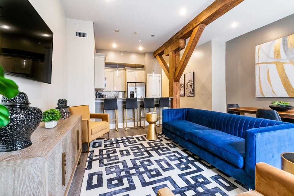 Open-concept living, kitchen, and dining area with plenty of seating. Enjoy a 65” Samsung Smart 4K TV with streaming and DIRECTV Entertainment. The sofa converts to a queen-size sleeper, and the dining table seats four. Lots of natural light too!