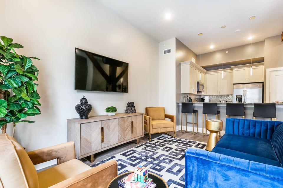 Open-concept living, kitchen, and dining area with plenty of seating. Enjoy a 65” Samsung Smart 4K TV with streaming and DIRECTV Entertainment. The sofa converts to a queen-size sleeper, and the dining table seats four. Lots of natural light too!