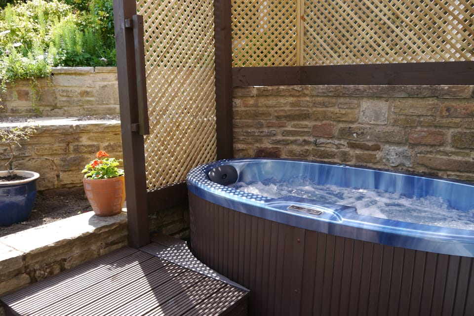 Hot tub just for two - covered so you can take a soak whatever the weather.