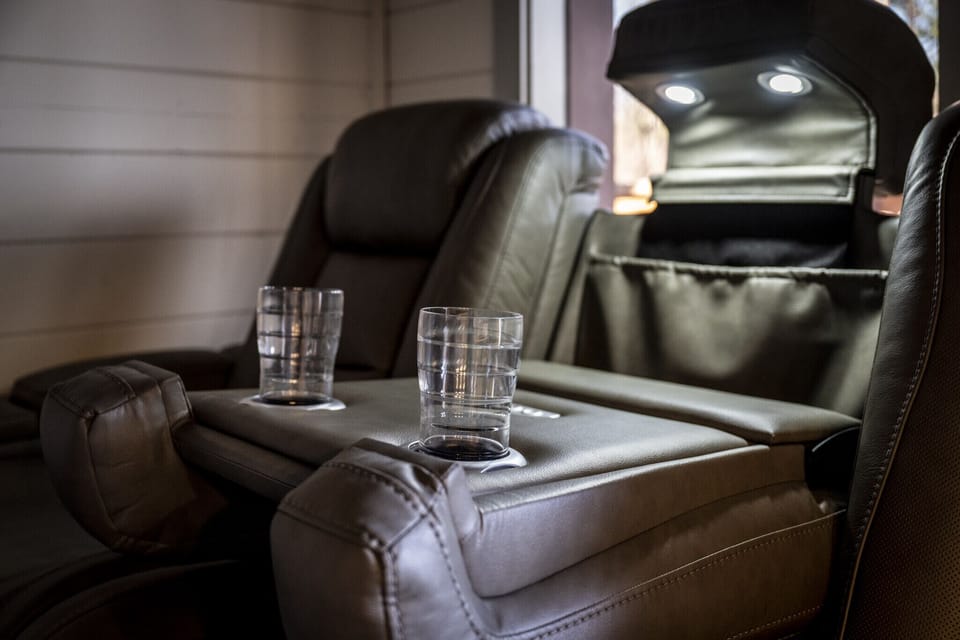 Four electric reclining chairs and wireless charging stations with cup holders and reading light.