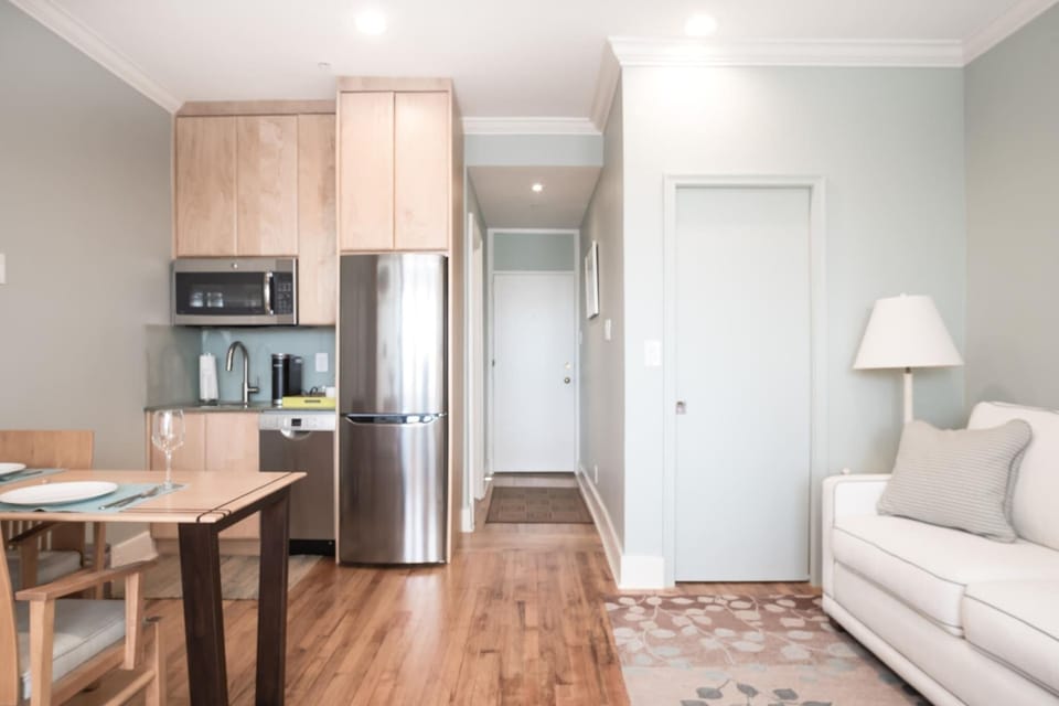 Queen Pull out. Dining Area, Kitchenette with microwave, fridge, Keurig coffee maker, glasses, plates, and cutlery
