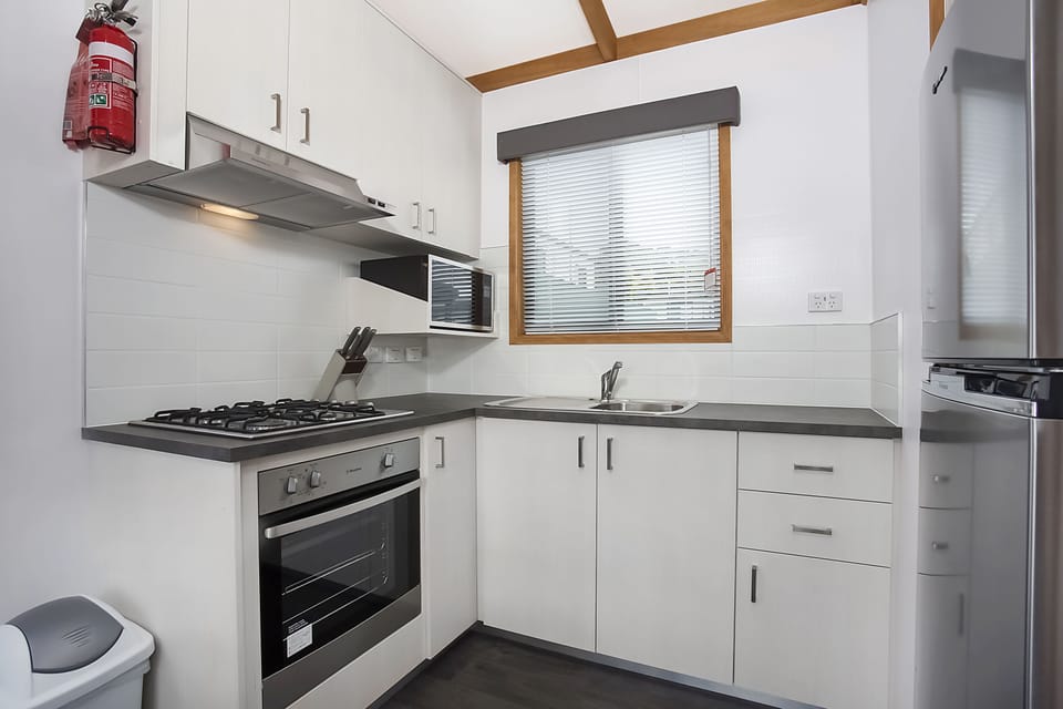 Deluxe Cabin, 2 Bedrooms | Private kitchen | Full-size fridge, microwave, stovetop, coffee/tea maker