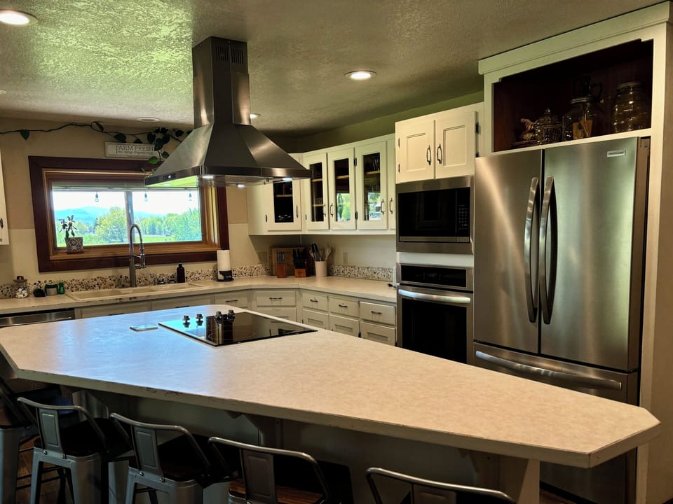 Cook and gather around the large island with all-new stainless appliances.