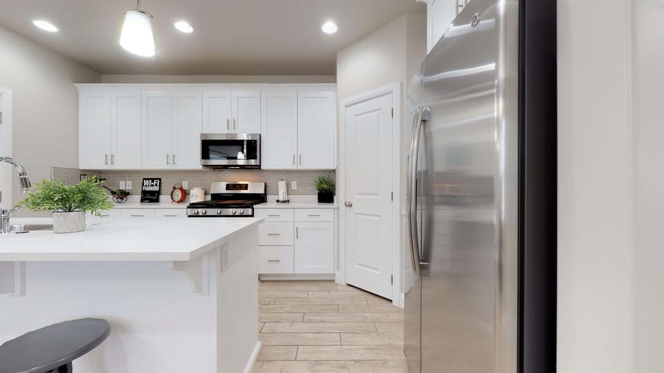 Fully stocked gourmet kitchen featuring stainless steel appliances
