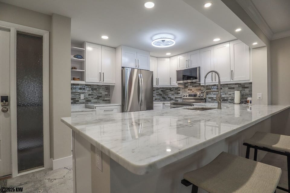 Gorgeous marble countertops, fabulous custom designed cabinets and backsplash and new appliances
