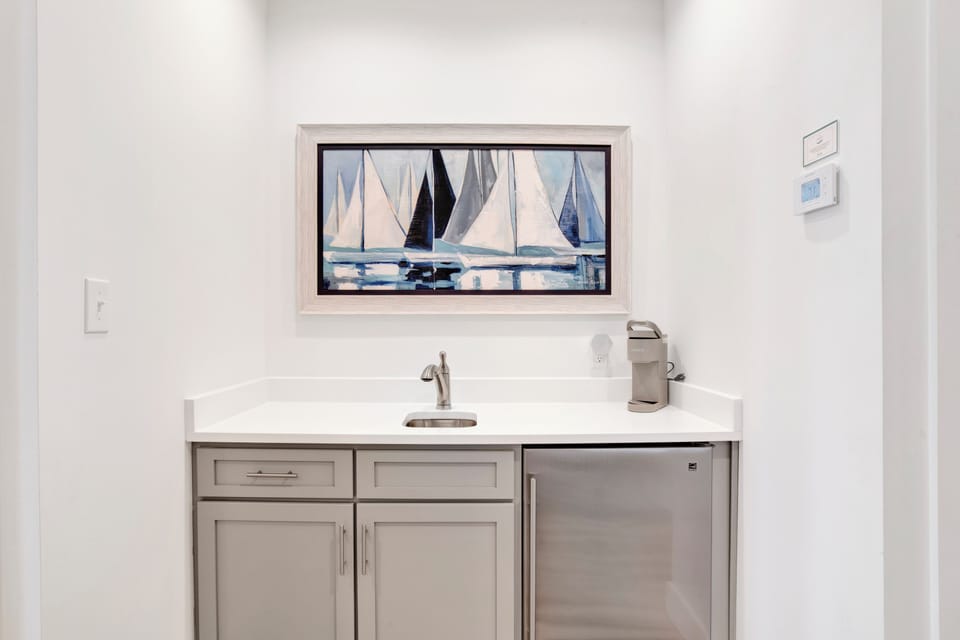 The wet bar offers a sink, mini fridge and Keurig coffee maker