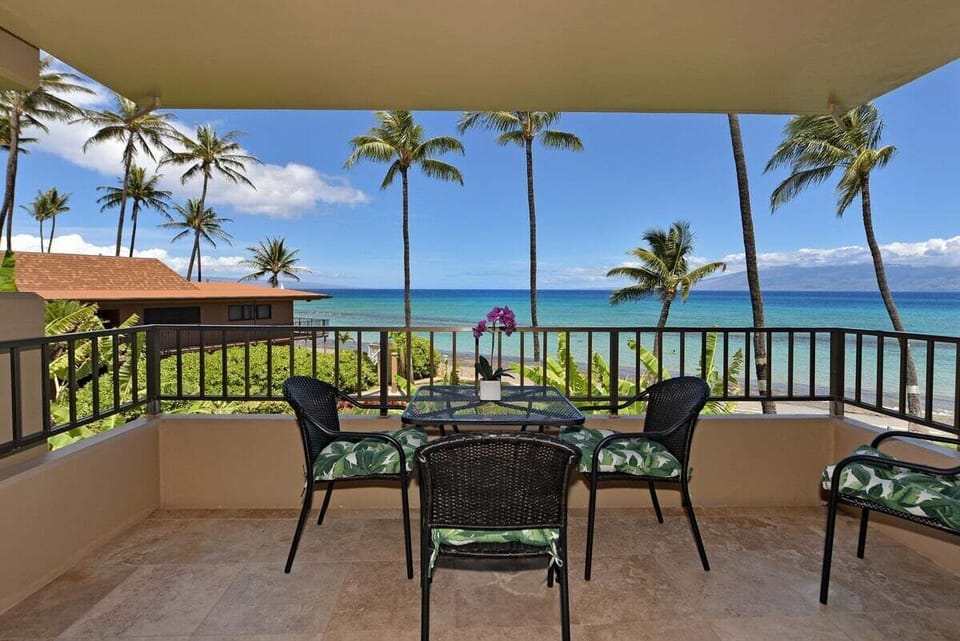 Spacious balcony with seating and panoramic ocean views.