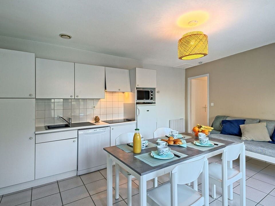 Cabinetry, Property, Furniture, Countertop, Table, Kitchen, Lighting, Interior Design, Flooring, Floor