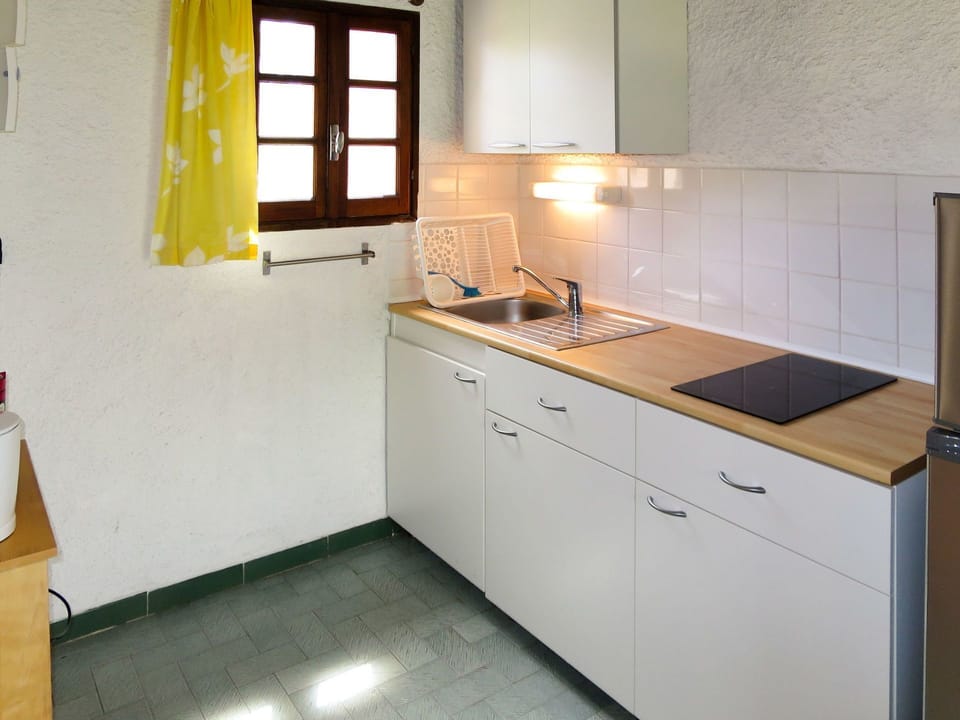 Room, Property, Kitchen, Countertop, Cabinetry, Furniture, Yellow, Kitchen Stove, Interior Design, Floor