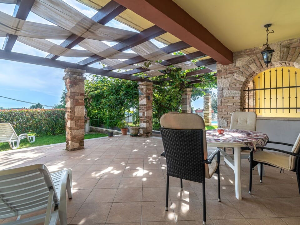Furniture, Outdoor Furniture, Chair, Flooring, Table, Resort, Outdoor Table, Shade, Patio, Flagstone