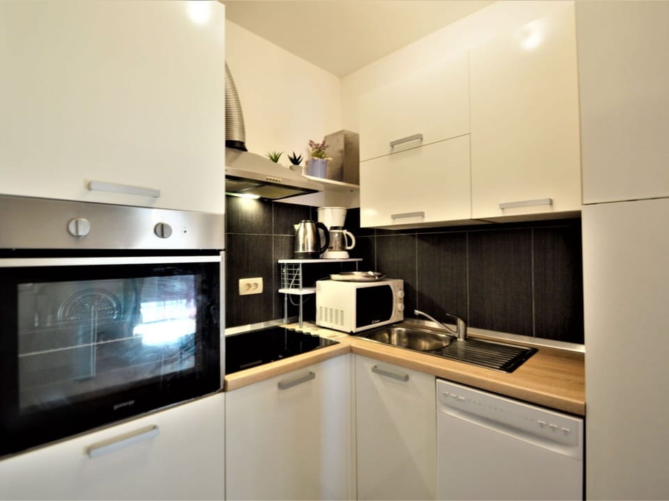 Cabinetry, Countertop, Kitchen Appliance, Kitchen Stove, Kitchen, Home Appliance, Gas Stove, Microwave Oven, Wood, Stove