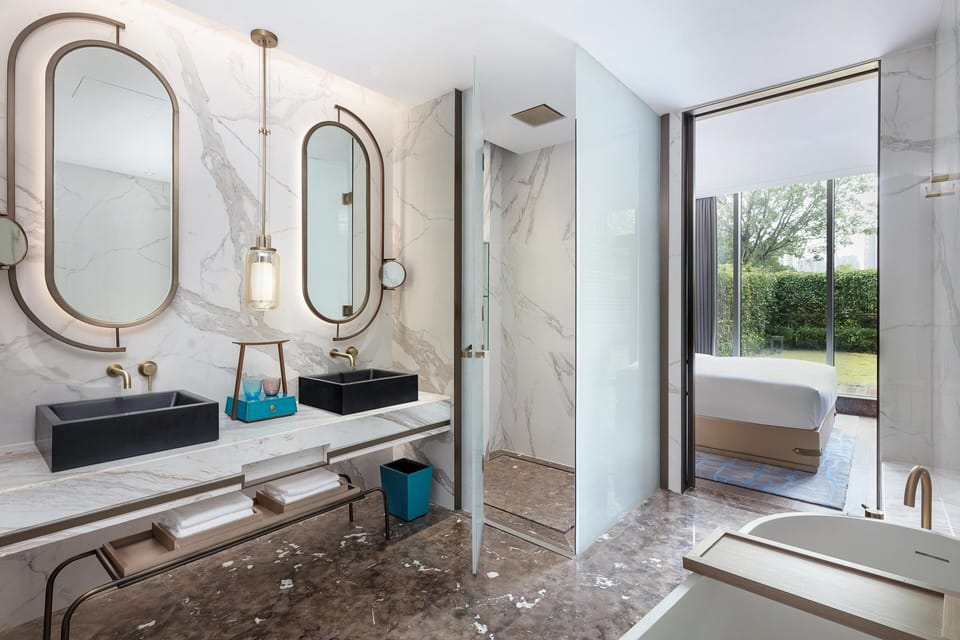 Suite, 1 King Bed | Bathroom | Separate tub and shower, designer toiletries, hair dryer, bathrobes