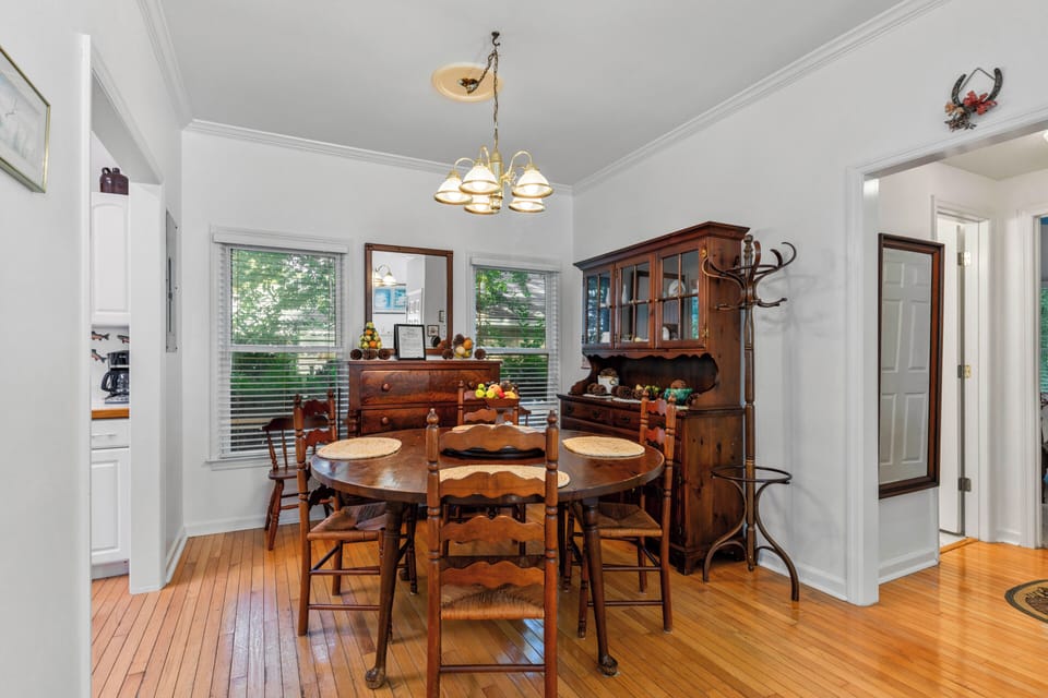 A charming dining space with warm wood furnishings and classic details, where you'll enjoy gathering around the table for memorable meals together.