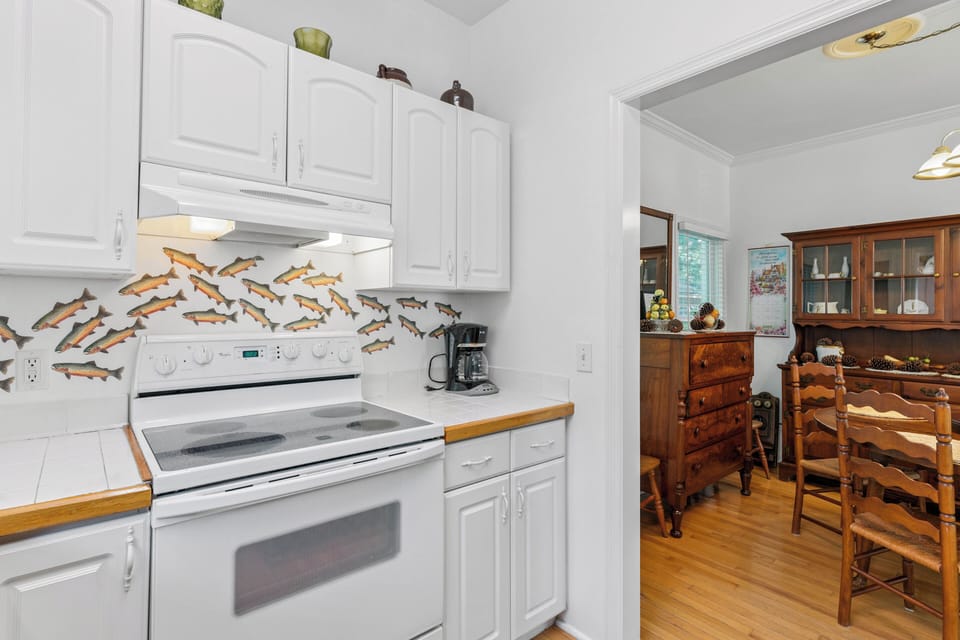 Fully equipped kitchen where you'll find everything you need to prepare your favorite meals, with a charming dining area just steps away for enjoying them together.