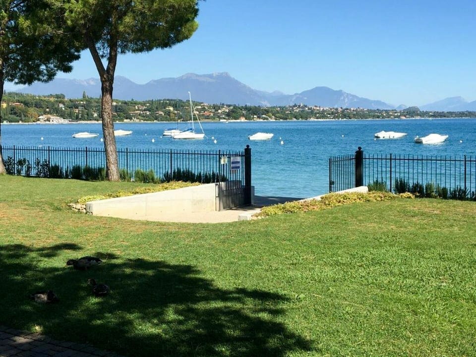 Water, Sky, Plant, Azure, Land Lot, Shade, Lake, Grass, Coastal And Oceanic Landforms, Natural Landscape