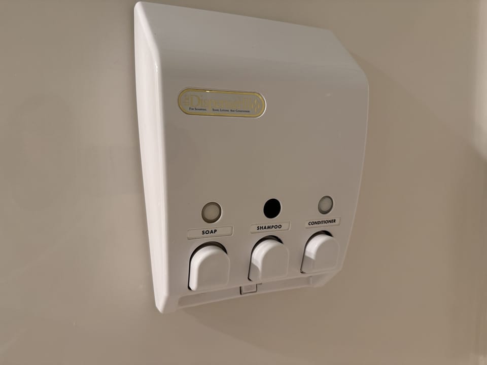 Shampoo, Conditioner, and Body Soap provided in dispensers in both bathrooms.