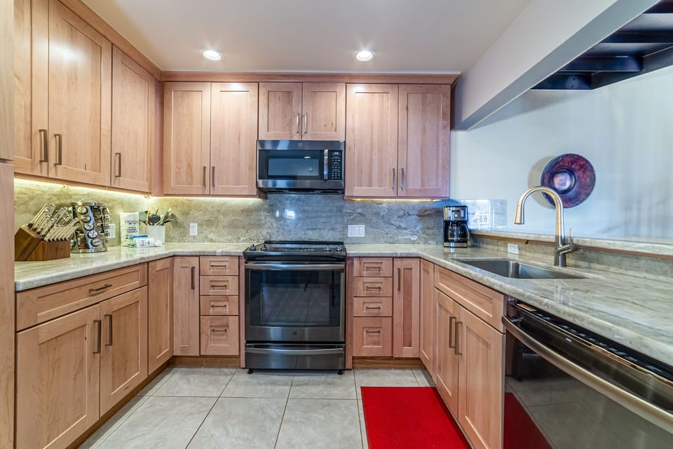 Kitchen has updated black stainless appliances.