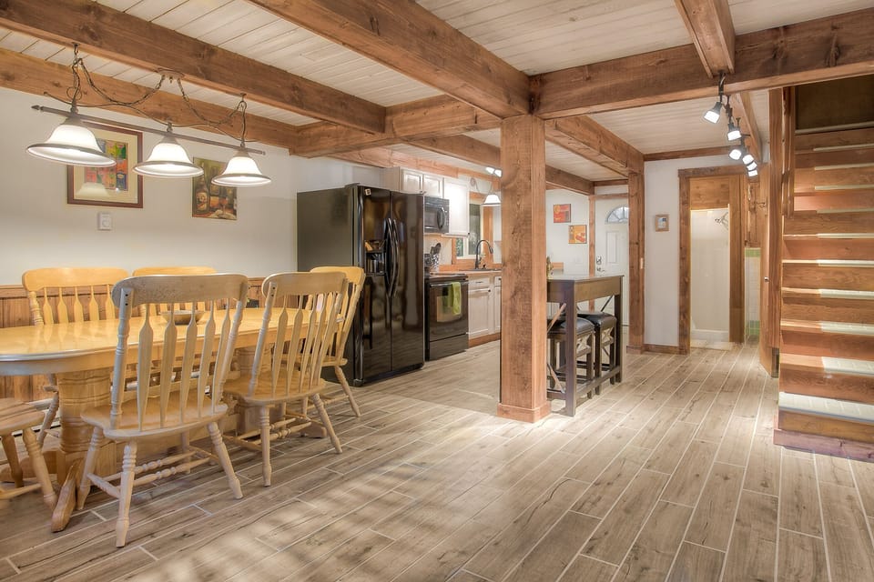 Spacious living, dining and kitchen area; washer & dryer tucked under stairs beside the bathroom