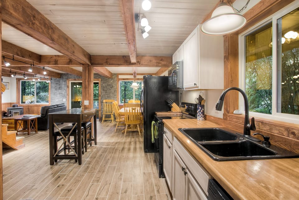 Fully equipped kitchen complete with dishwasher, full-sized fridge, and stove/oven