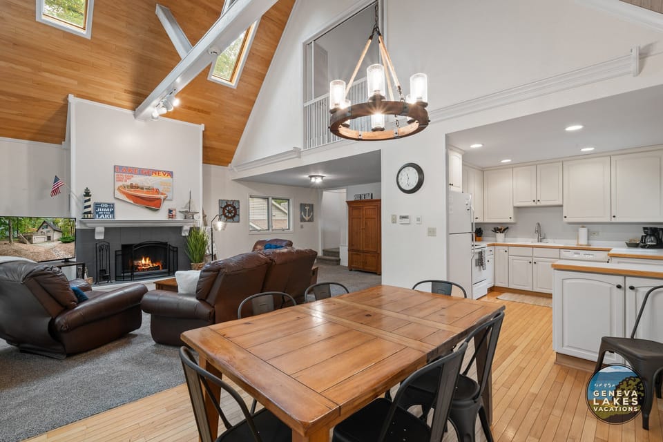 Open concept dining to living room. Living room has smart TV and fireplace