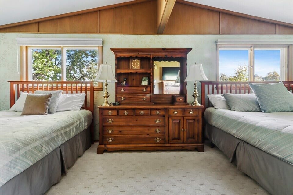 Master upper level bedroom with 2 beds, a king and a queen for ample sleeping. Shared bath.